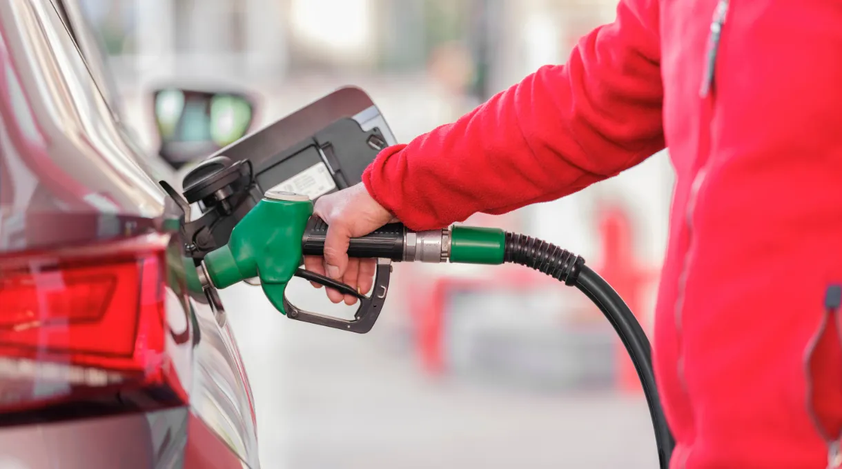 A customer fueling up a vehicle at a convenience store gas pump