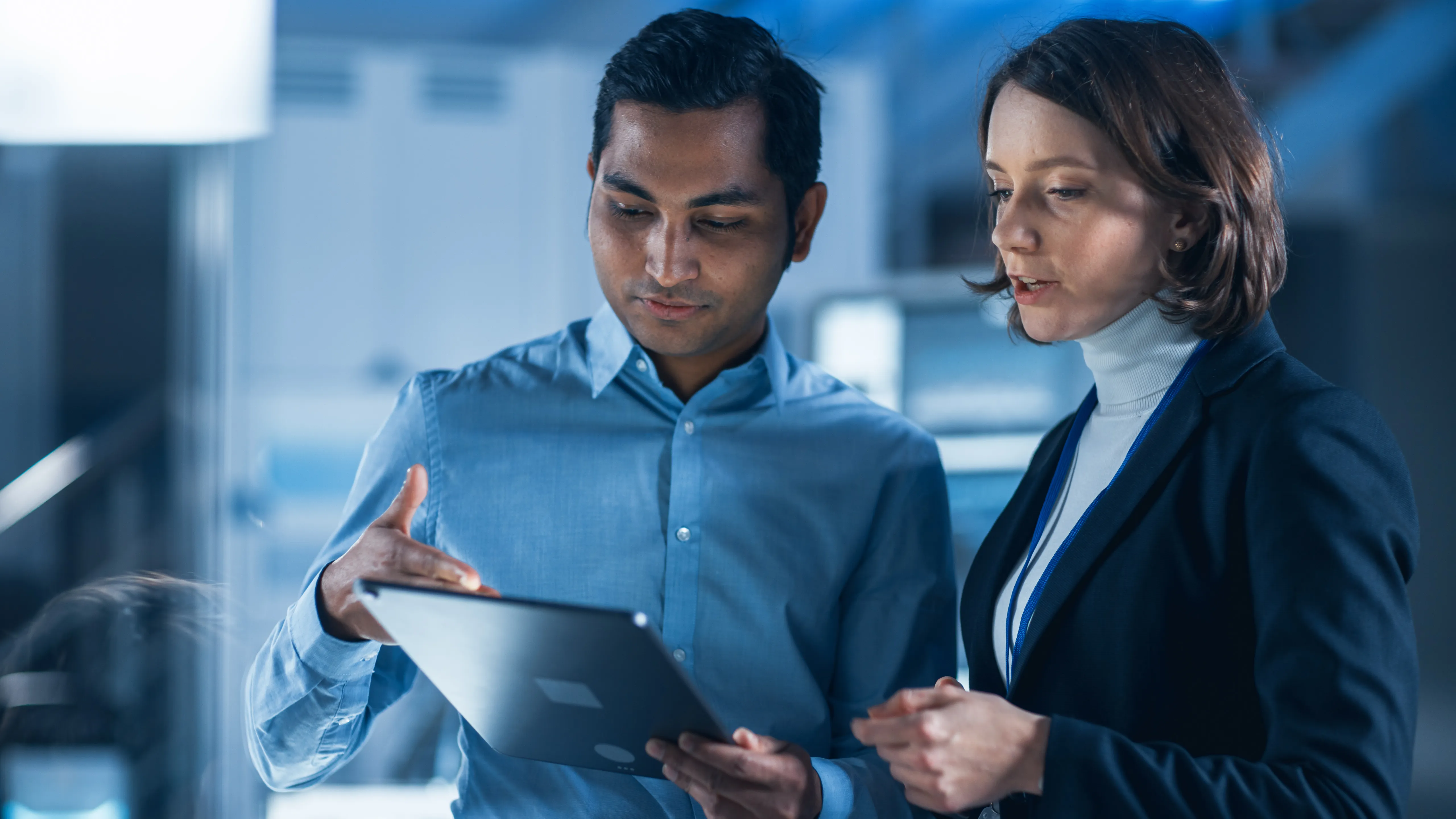 Two facilities managers reviewing work orders together at a job site